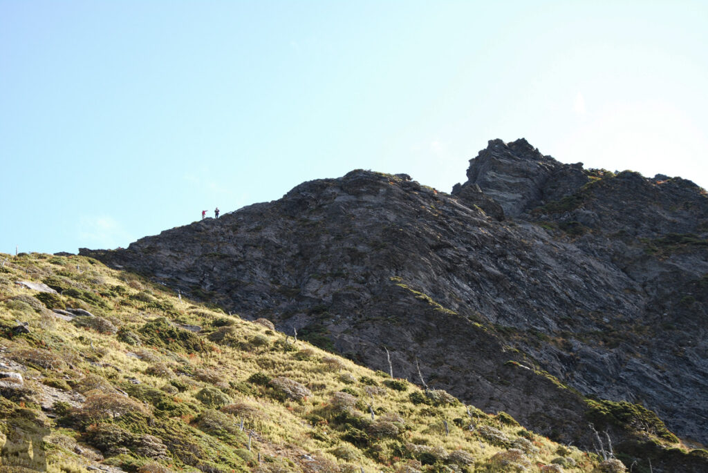 The Death Ridge (死亡稜線), the Climb on a Razor-Sharp Ridge between North Section 1 and North Section 2, Central Mountain Range two hikers on the top of sheer cliff