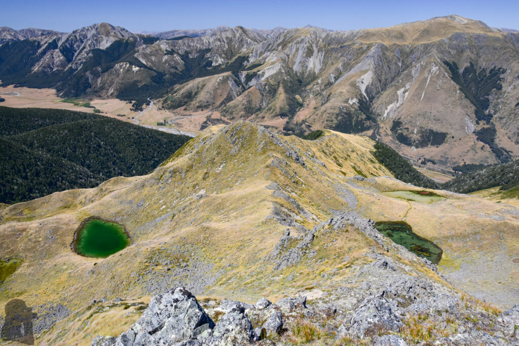 Faust, a Day Hike to the Peak with lovely Tarns on an Unnamed Track The four tarns underneath the summit with two on each side of the ridge where I was descending.