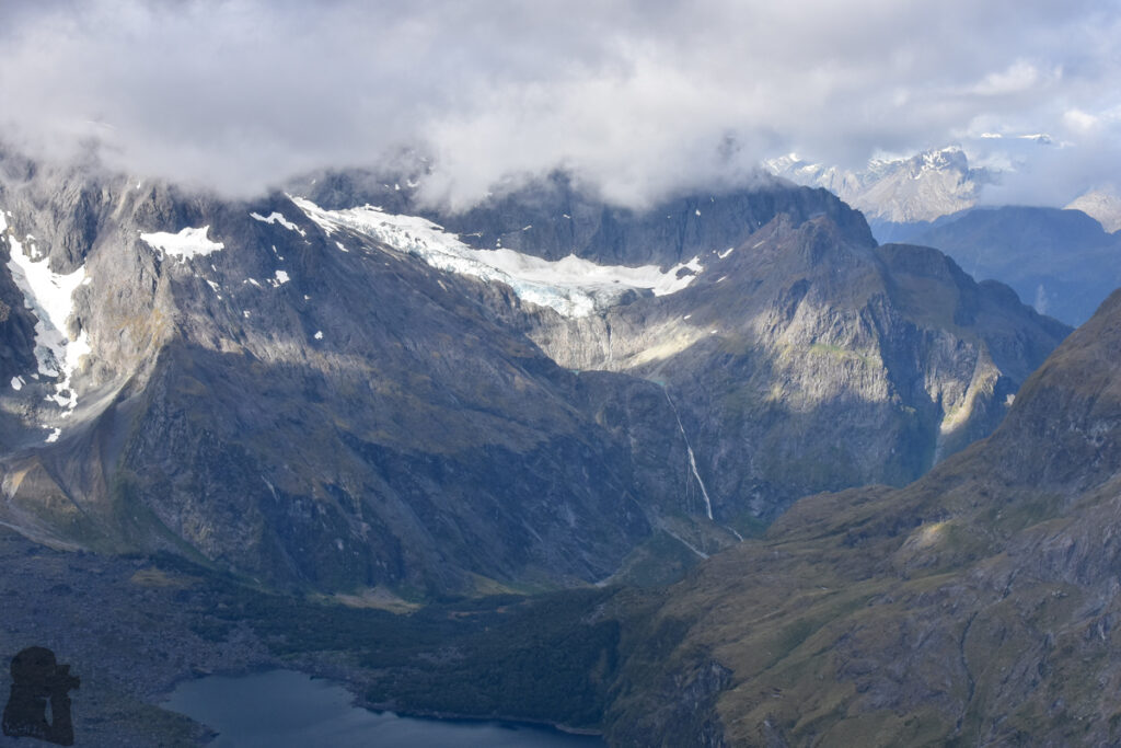 A camp near Barrier Knob; overlooking the dreamy Gertrude Valley and Lake Adelaide An unnamed hidden lake under Korako Glacier; and the 300 m drop of the super waterfall from the lake.
