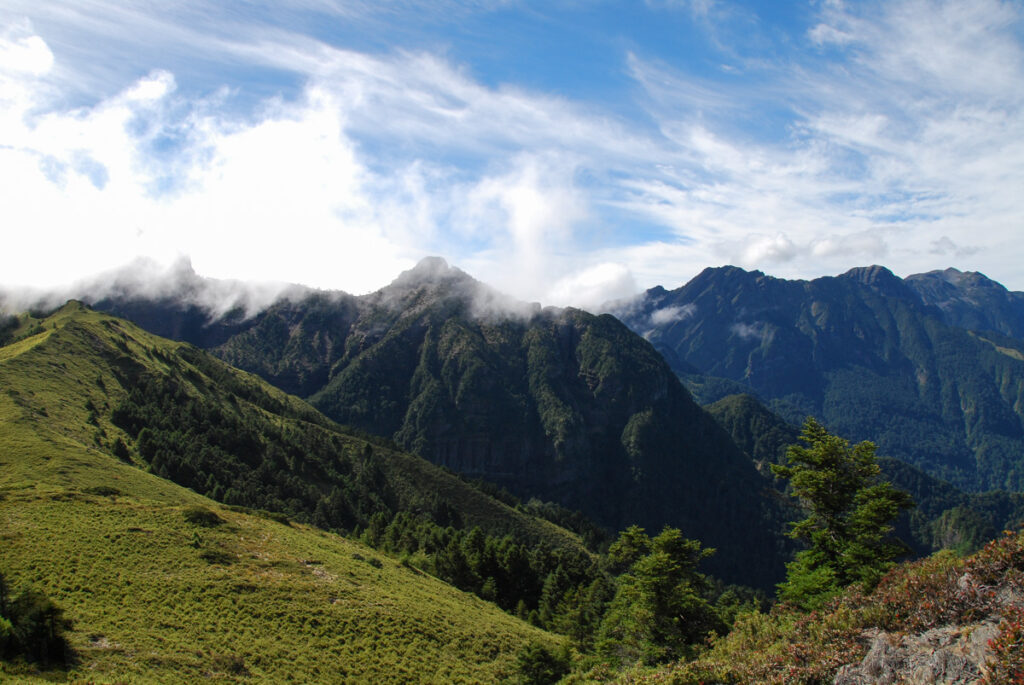 Dabajianshan (大霸尖山), the Iconic High Mountain with the Imposing Summit The view for nearly the full length of Holy Ridge, from Dabajianshan (hidden in the cloud on the left) to Xueshan North Corner (雪山北稜角) in the distance on the right.