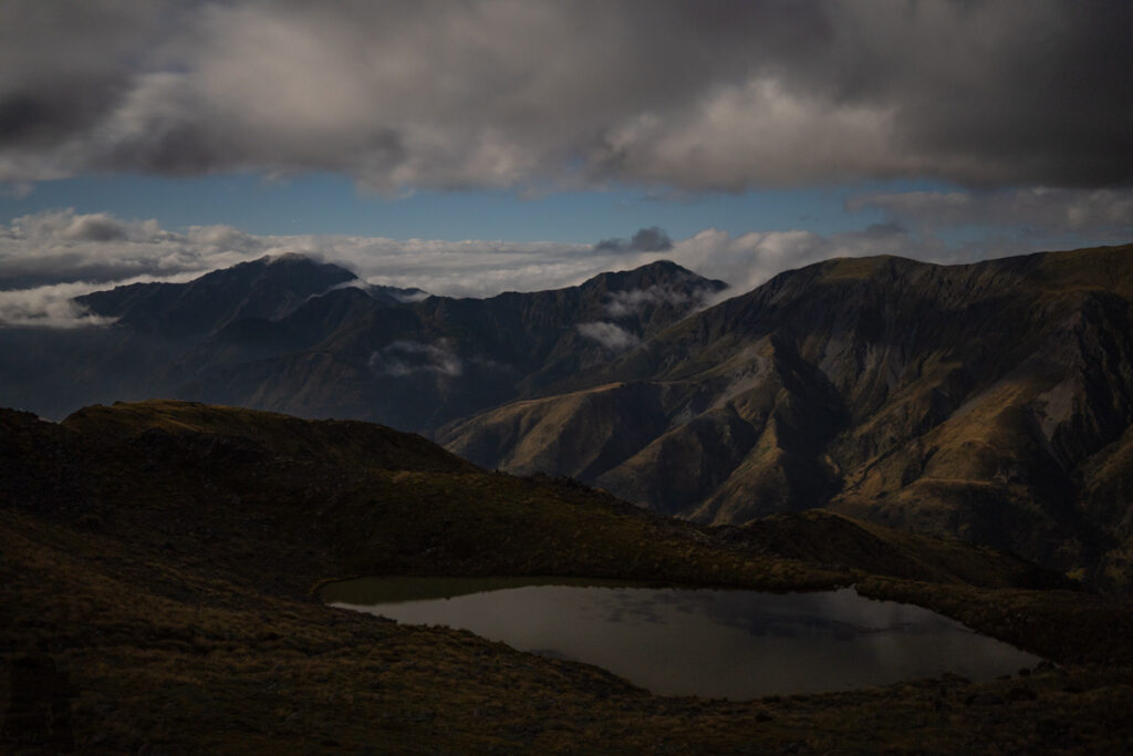 Faust, Libretto Range, Camp by its Colorful Tarns on the Ridge A bright night sky over the lower tarn