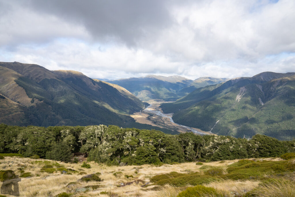 Faust, Libretto Range, Camp by its Colorful Tarns on the Ridge The bushline where there is a small campsite, a tank holding rainwater and an old wooden sign