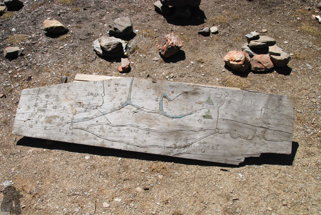 A very old sign with the handmade-style map