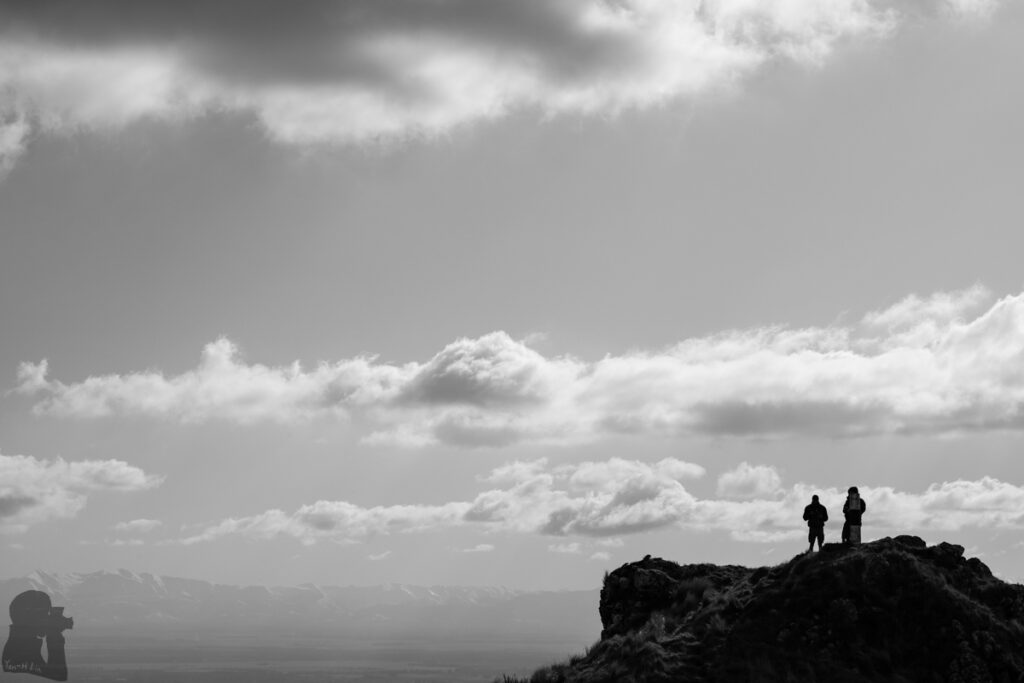 Te Moenga-o-Wheke / The Tors, the Prominent Peak on Port Hills for Viewing the Panorama of Canterbury Two men stood on the peak of The Tors.