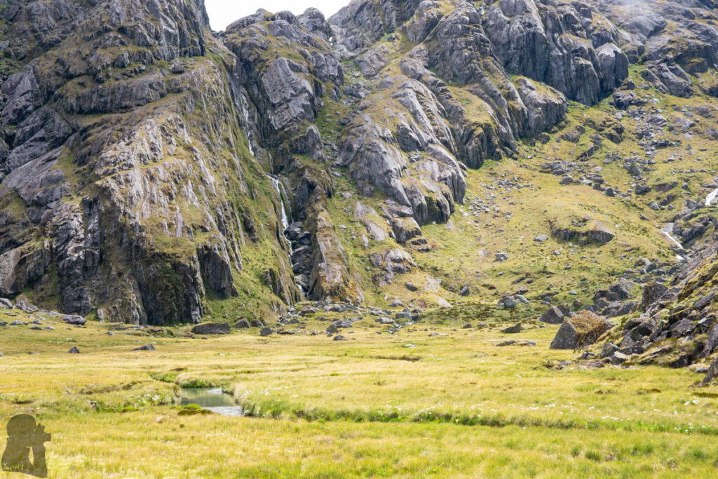Valley of the Trolls / Lake Wilson, the Best Hidden Destination via Routeburn Track Looking toward the waterfall going off from the outlet of Lake Wilson and the route we will climb