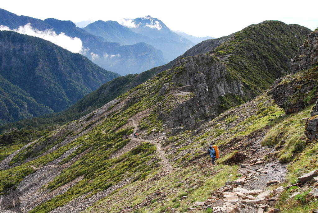Climbing along the edge of the Xueshan Cirque